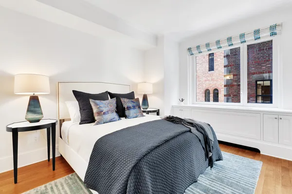 a bedroom with a bed and window