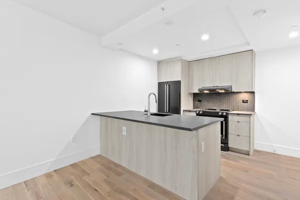 a kitchen with stainless steel appliances granite countertop a sink and a stove