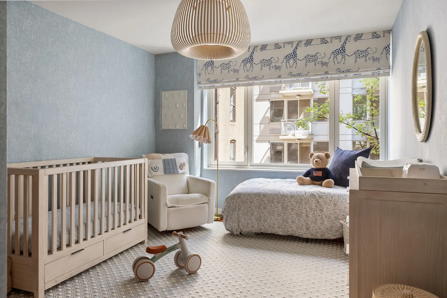 a bedroom with furniture and a large window
