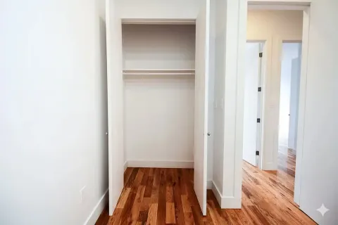 a view of a room with wooden floor