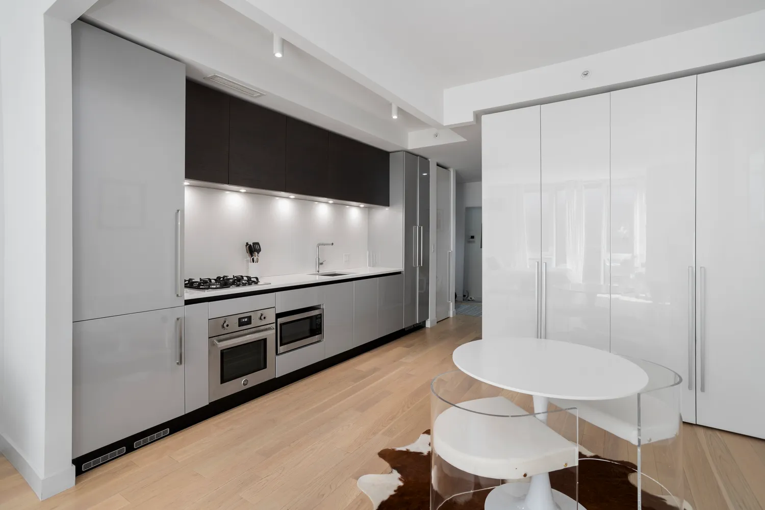 a kitchen with stainless steel appliances a stove a table and chairs