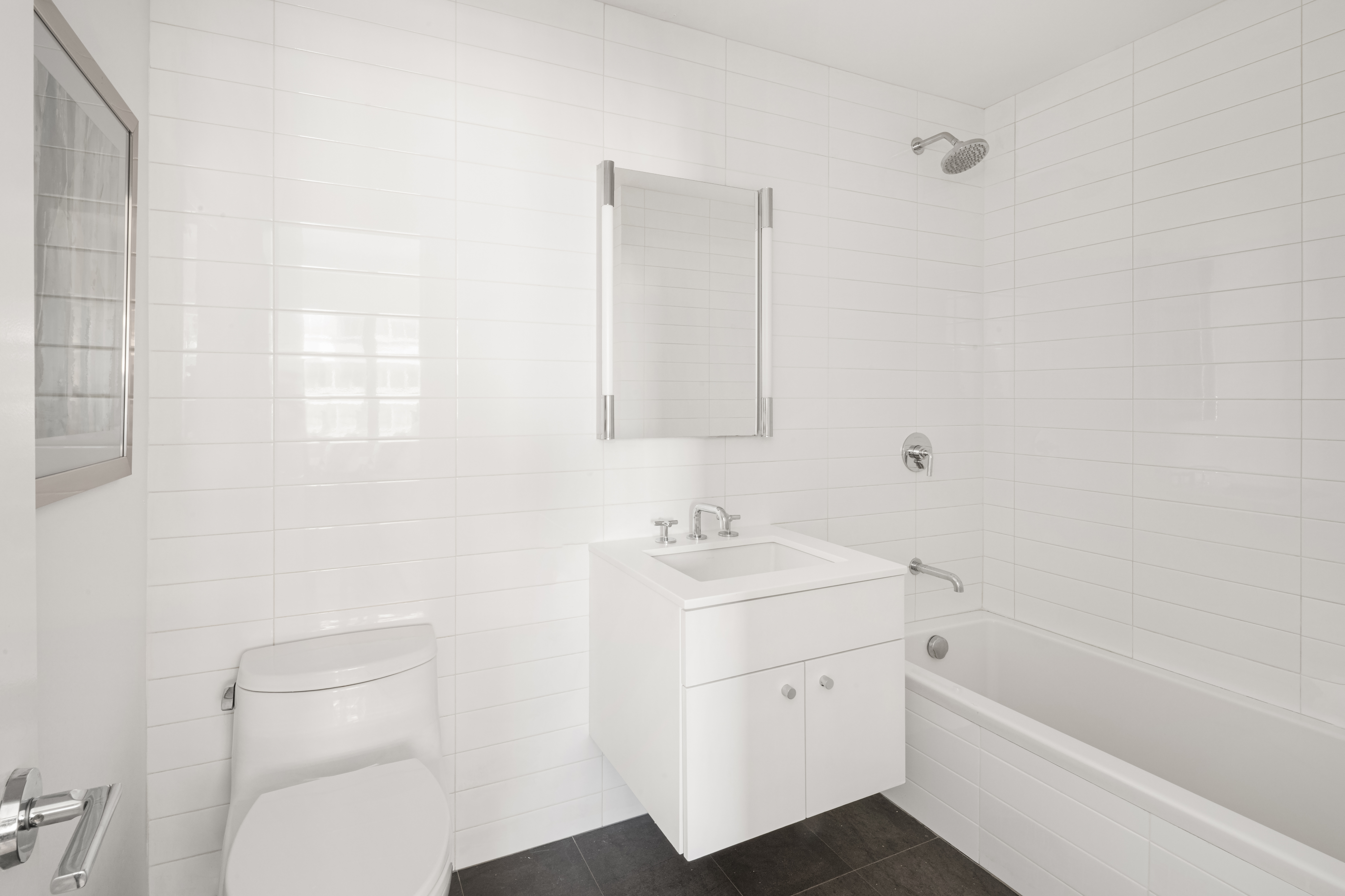 200 East 62nd Street, Unit 27A Manhattan, NY 10065 - Photo 11 of 19 a bathroom with a toilet a sink and a bathtub