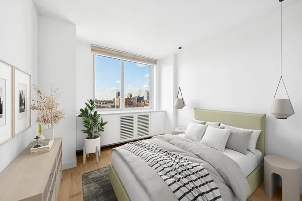 a bedroom with a bed and a potted plant