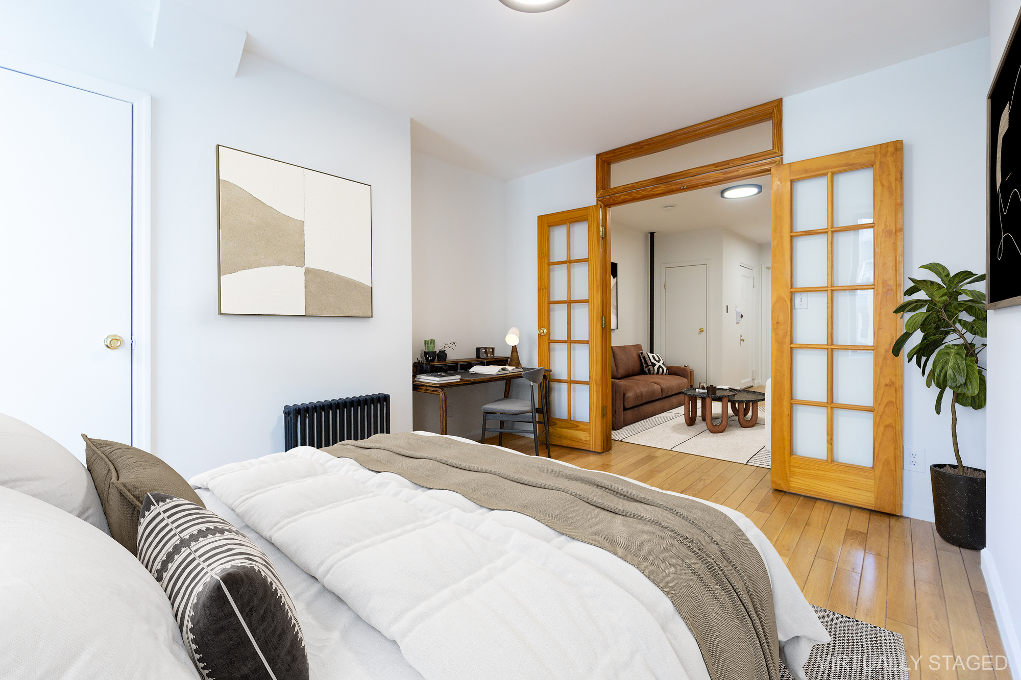 337 East 6th Street, Unit 9 Manhattan, NY 10003 - Photo 3 of 15 a bedroom with a bed and a large mirror