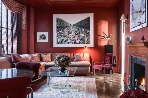 a living room with furniture a rug and a fireplace