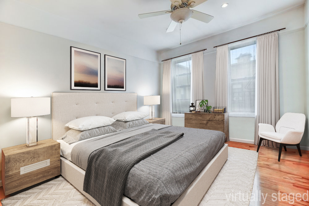 779 Riverside Drive, Unit B60 Manhattan, NY 10032 - Photo 3 of 9 a bedroom with a large bed and a chandelier