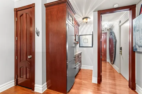 a view of a hallway with wooden floor and staircase