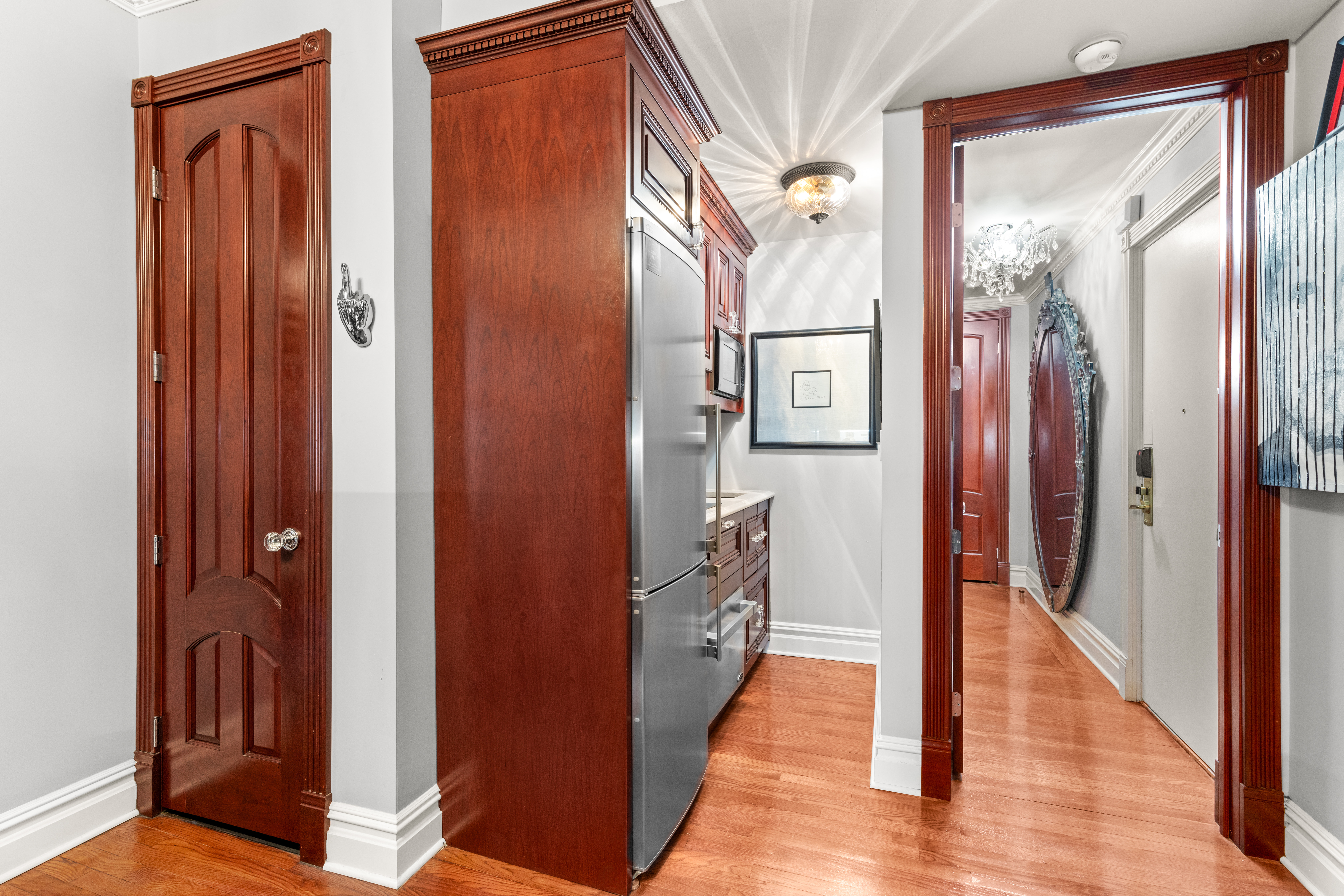575 Park Avenue, Unit 108 Manhattan, NY 10065 - Photo 11 of 18 a view of a hallway with wooden floor and staircase