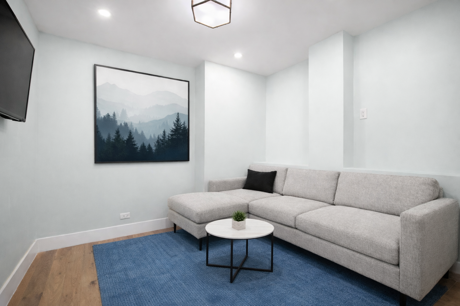70 East 10th Street, Unit 4V Manhattan, NY 10003 - Photo 8 of 26 a living room with furniture and a wooden floor