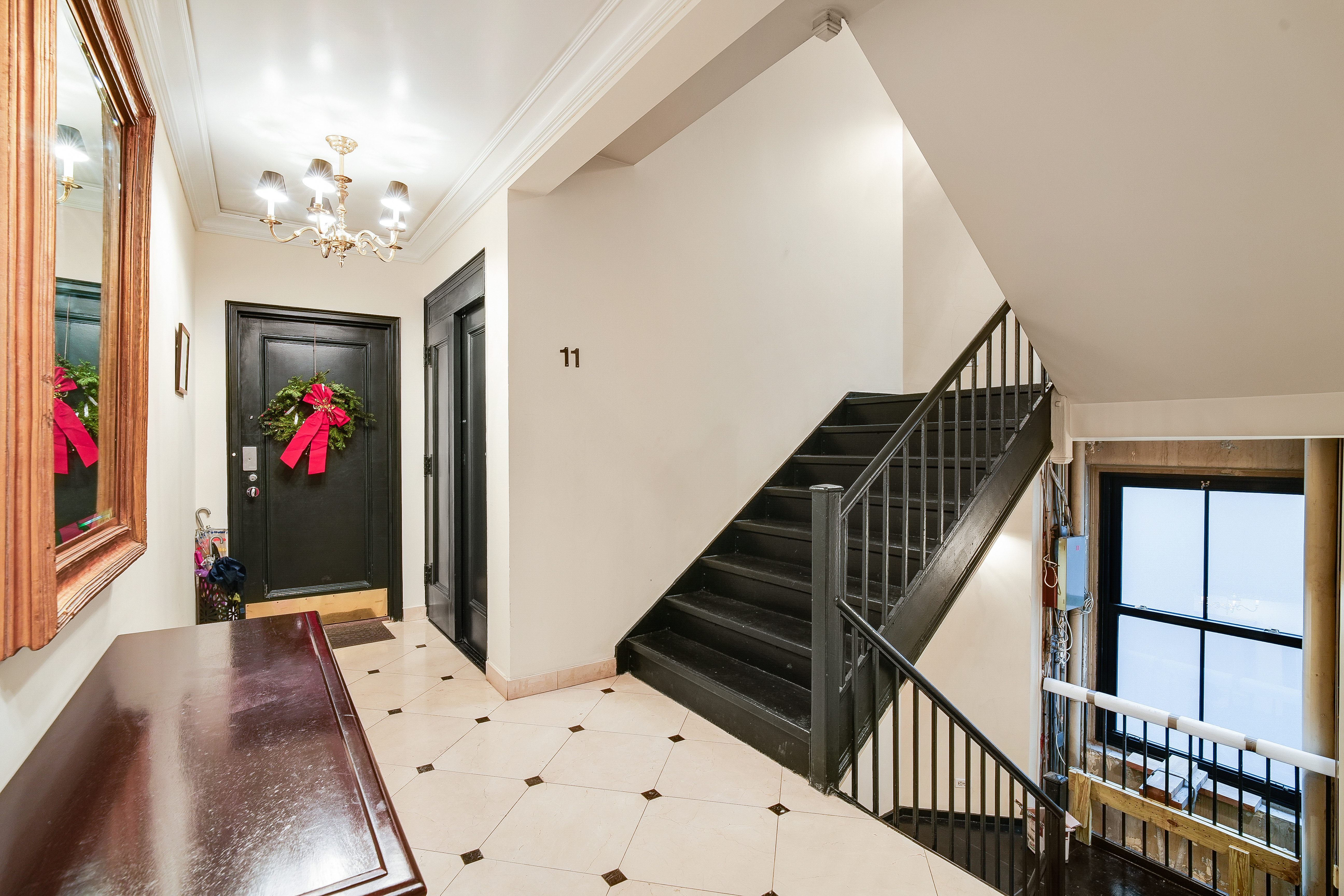 1060 Park Avenue, Unit 11A Manhattan, NY 10128 - Photo 10 of 12 a view of a hallway with front door and wooden floor