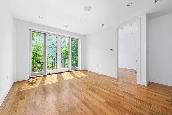 18 A Bleecker Street, Unit 4B Brooklyn, NY 11221 - Photo 3 of 11 a view of an empty room with wooden floor and a window