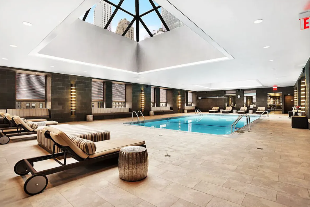 225 Rector Place, Unit 2D Manhattan, NY 10280 - Photo 9 of 17 a living room with furniture gym equipment and a view of living room