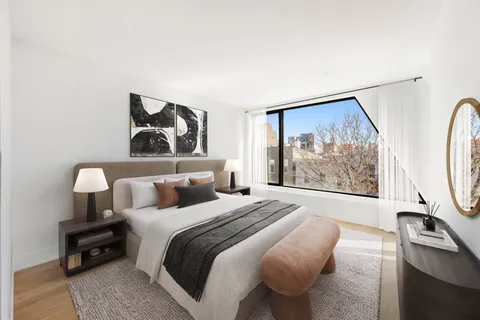 a bedroom with bed and a painting on the wall