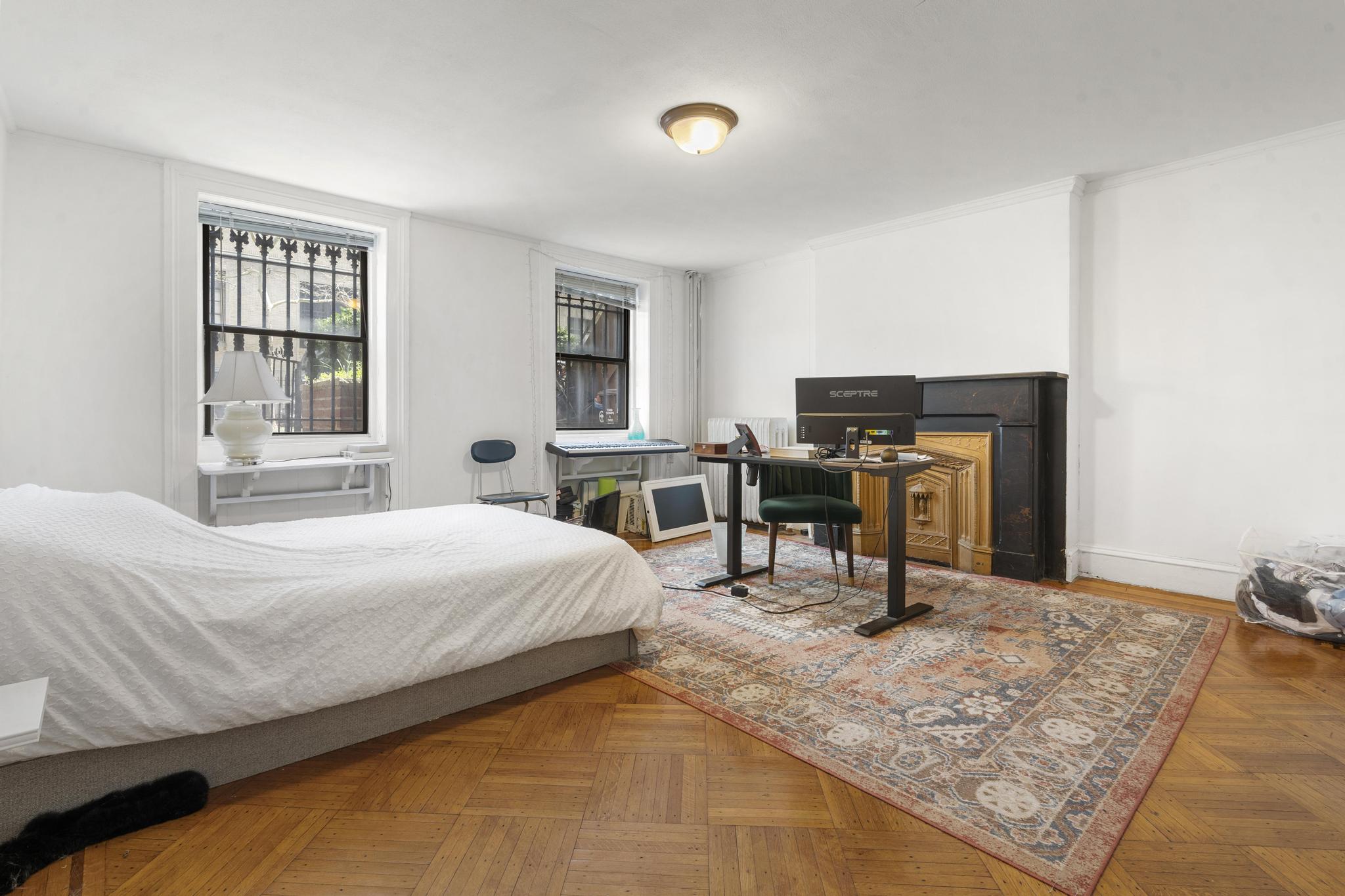 364 Clermont Avenue Brooklyn, NY 11238 - Photo 9 of 18 a bedroom with a bed a table and chair