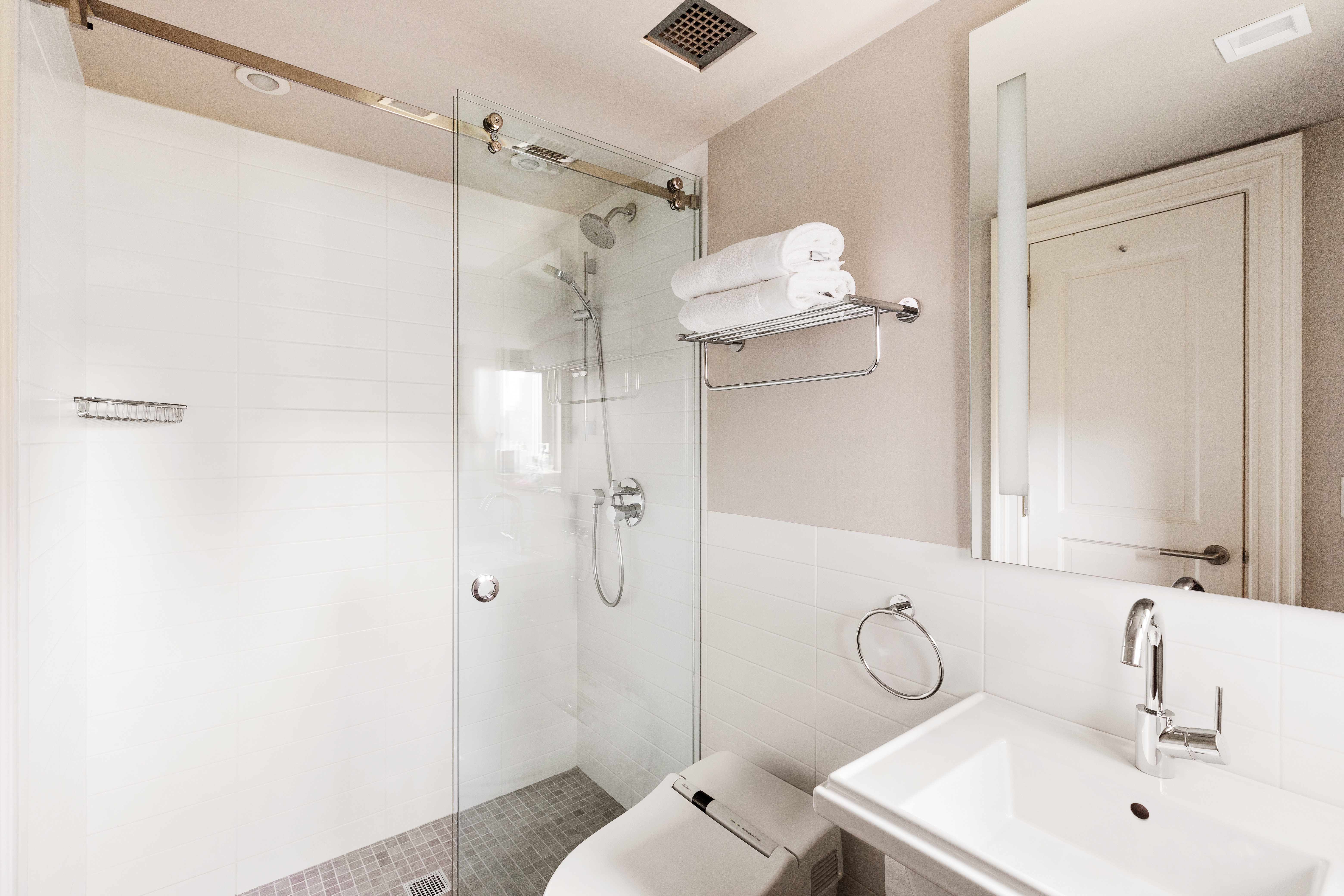 25 East 83rd Street, Unit 10D Manhattan, NY 10028 - Photo 8 of 17 a bathroom with a sink a toilet and shower