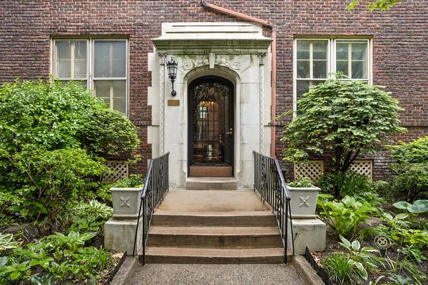 a front view of a house with plants