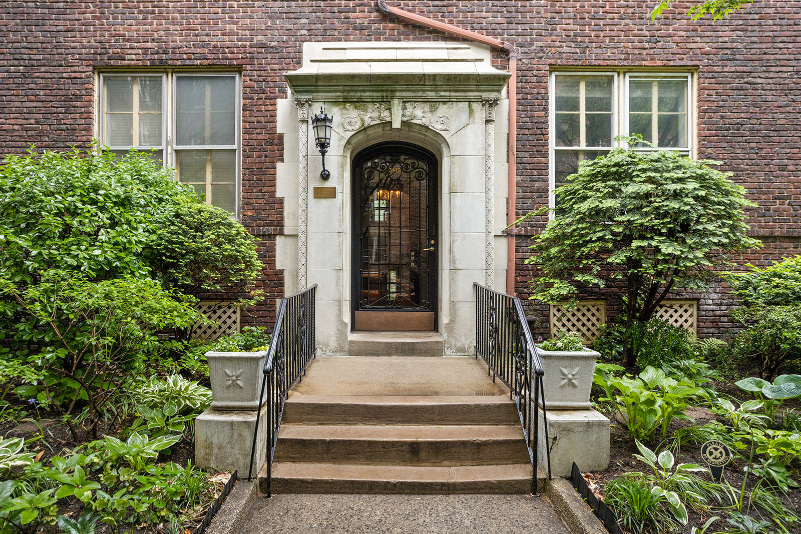 34-13 80th Street, Unit 31 Queens, NY 11372 - Photo 15 of 16 a front view of a house with plants