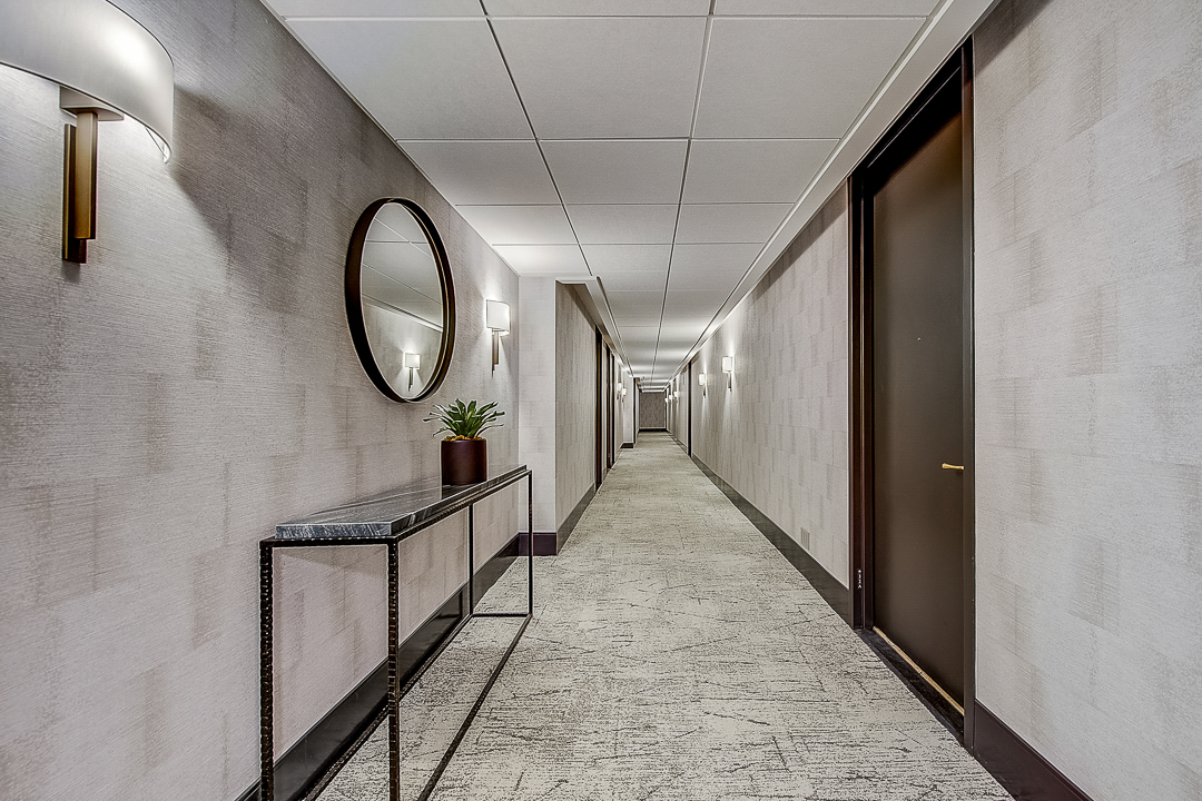 111 West 67th Street, Unit 24L Manhattan, NY 10023 - Photo 8 of 10 a view of a hallway with wooden floor and staircase