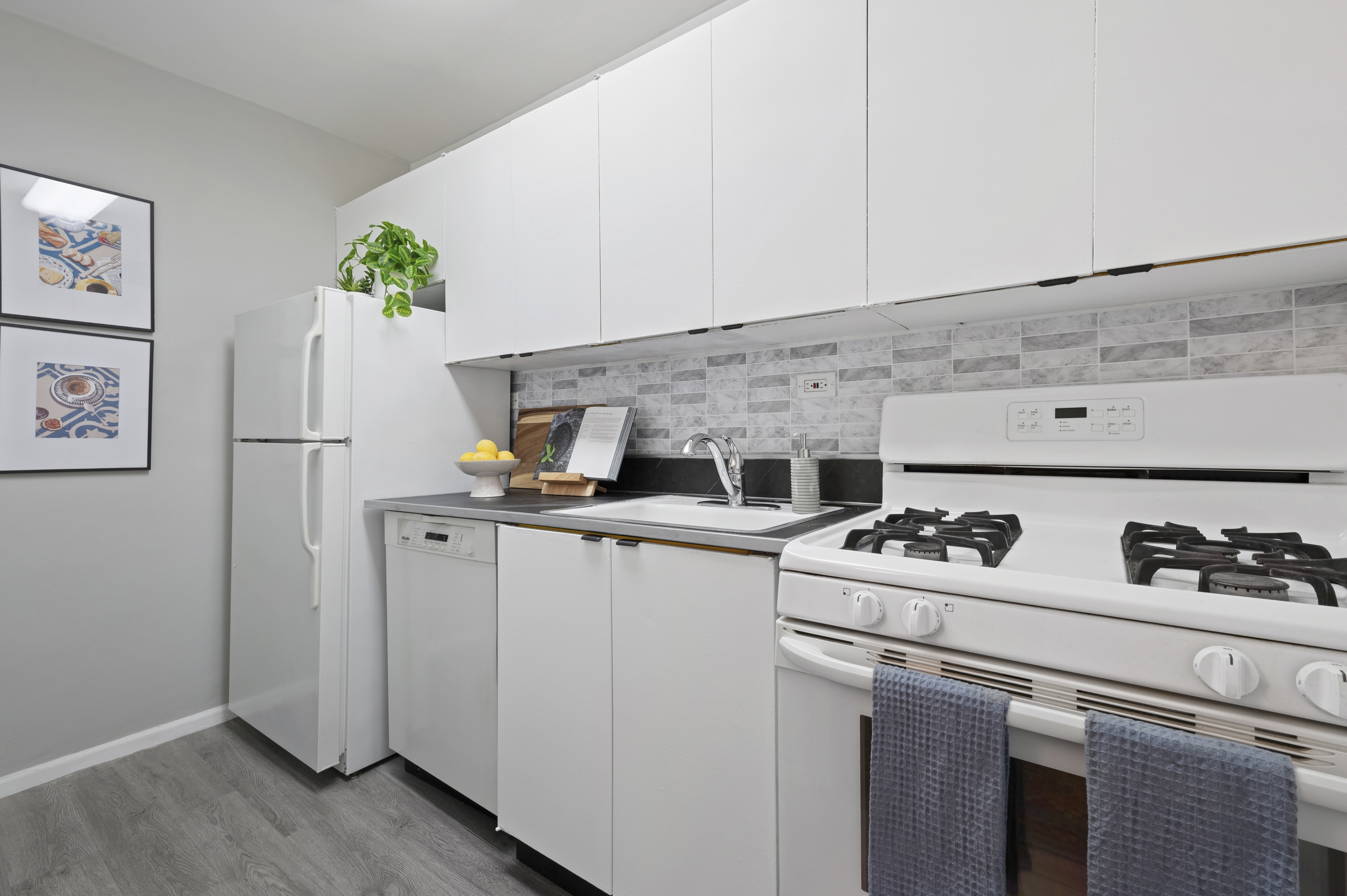 315 East 70th Street, Unit 7D Manhattan, NY 10021 - Photo 5 of 16 a kitchen with stainless steel appliances a stove a refrigerator and a counter space