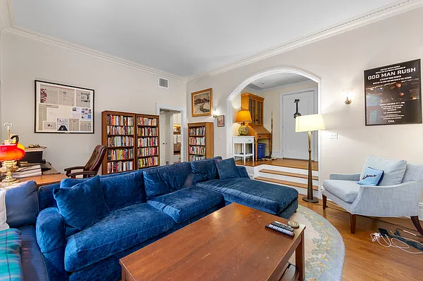 1 West 67th Street, Unit 2M Manhattan, NY 10023 - Photo 2 of 16 a living room with furniture and a wooden floor