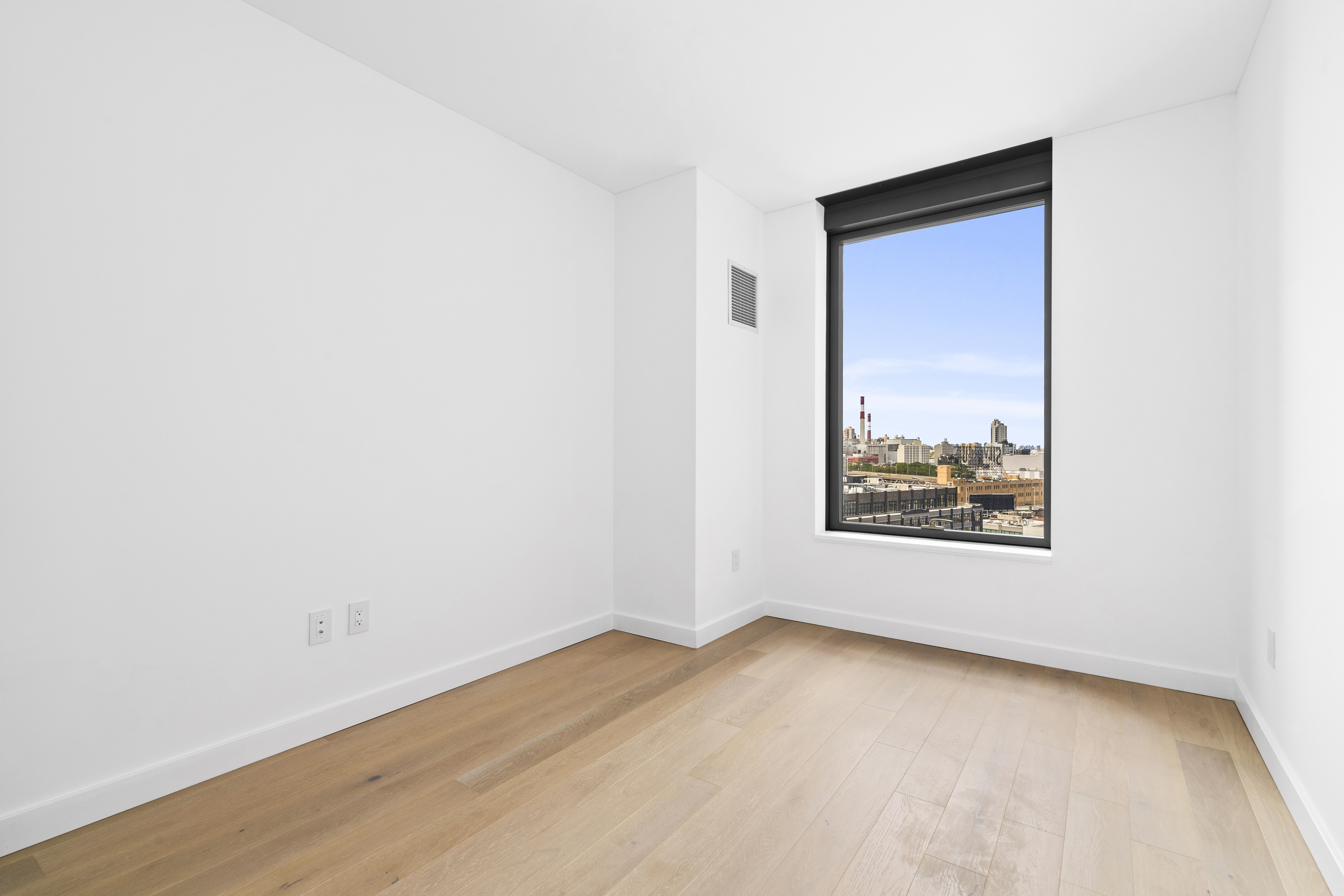 3 Court Square, Unit 1207 Queens, NY 11101 - Photo 5 of 9 an empty room with a window