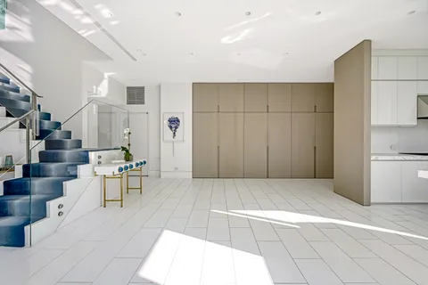 a view of kitchen with furniture and refrigerator