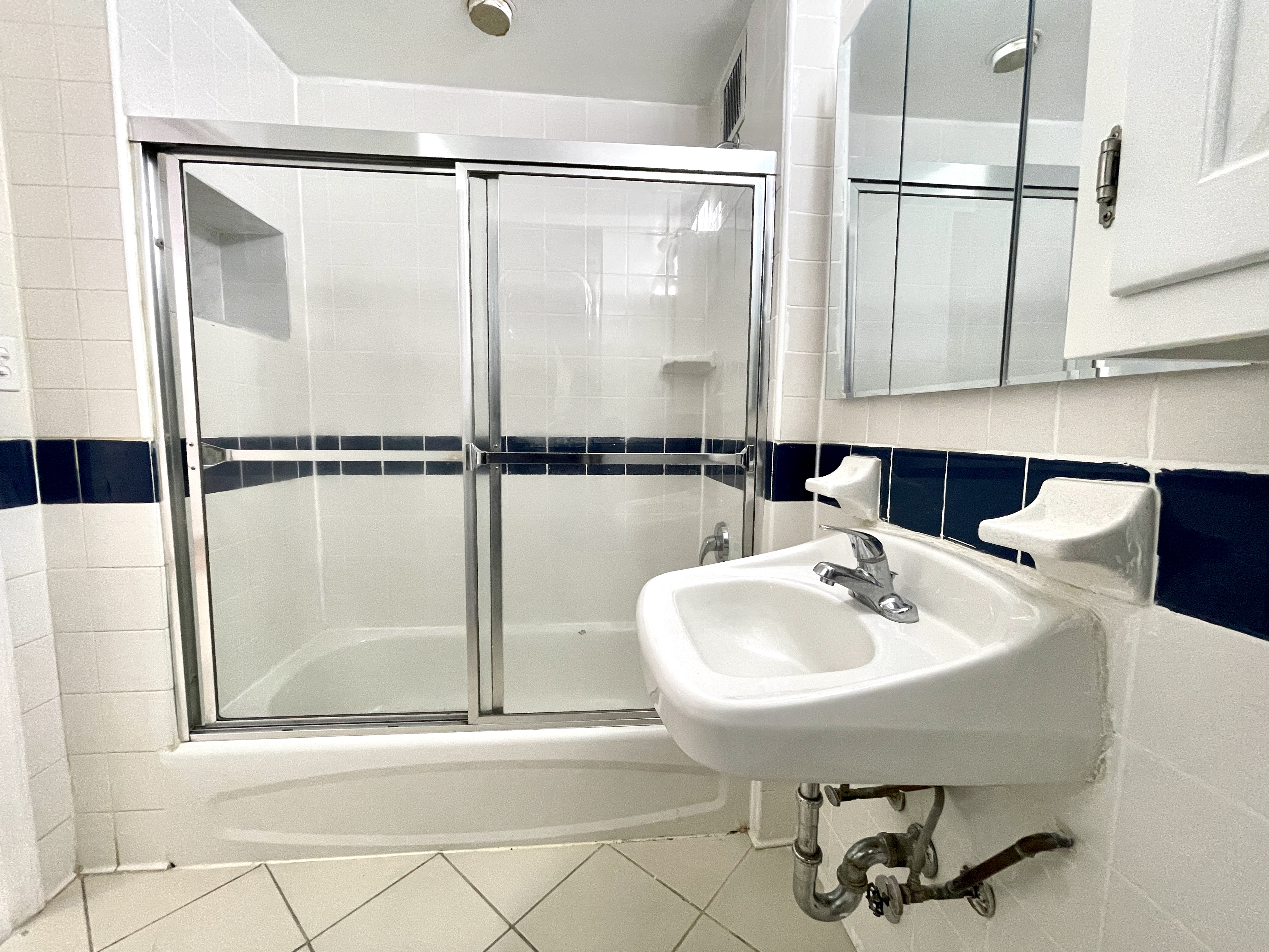 148A Madison Street, Unit 4 Manhattan, NY 10002 - Photo 11 of 13 a bathroom with a sink and mirror