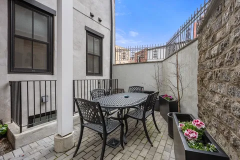 a backyard of a house with table and chairs