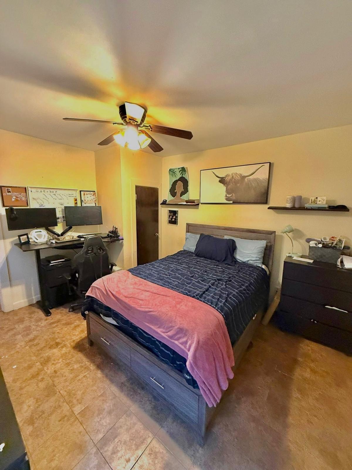 883 East 165th Street, Unit 1F Bronx, NY 10459 - Photo 5 of 7 a spacious bedroom with a bed and ceiling fan