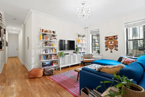 a bedroom with furniture and a flat screen tv