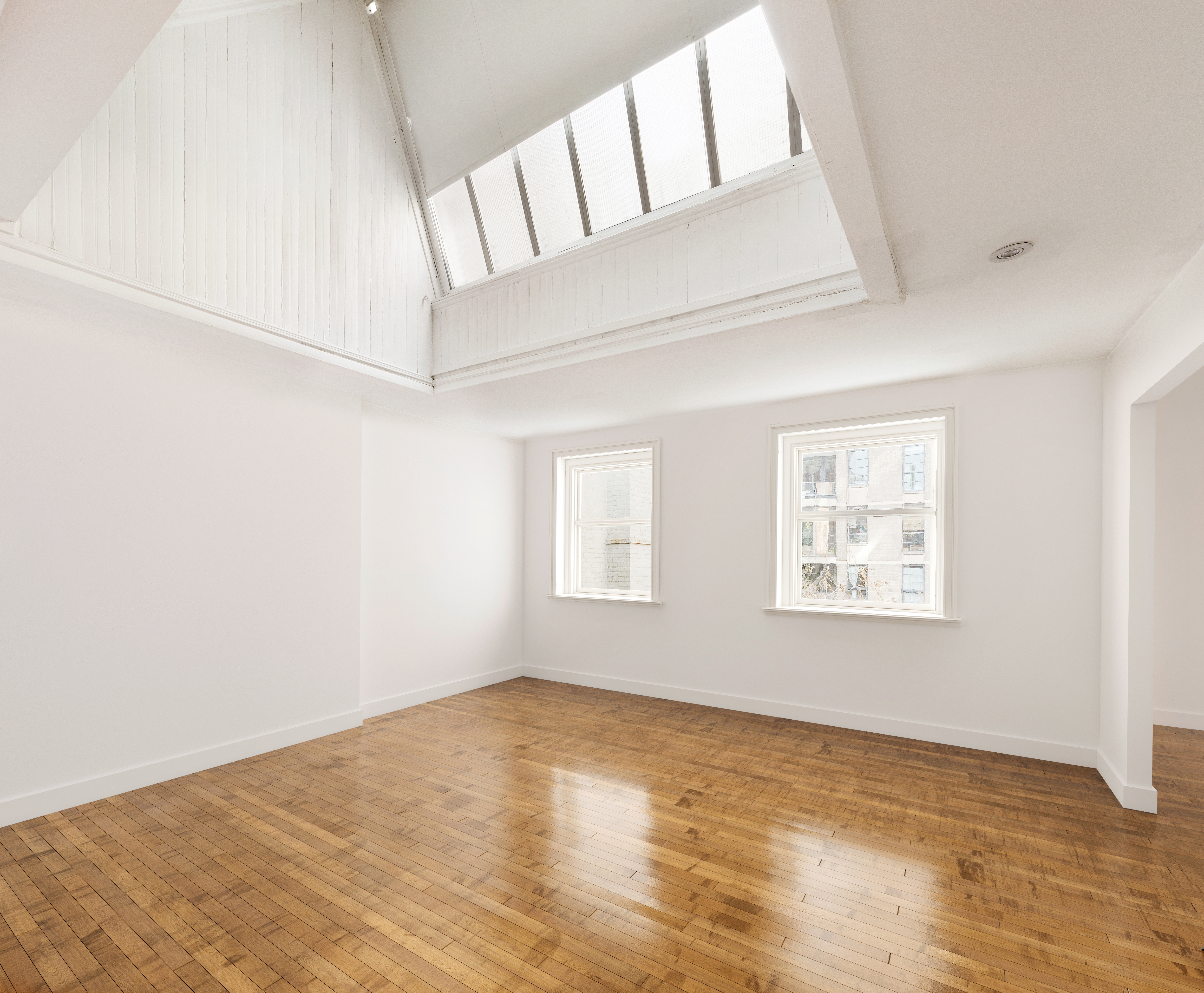 23 West 12th Street, Unit 4/5 Manhattan, NY 10011 - Photo 5 of 8 a view of an empty room with wooden floor and a window
