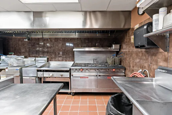 a kitchen with granite countertop a stove a sink and dishwasher
