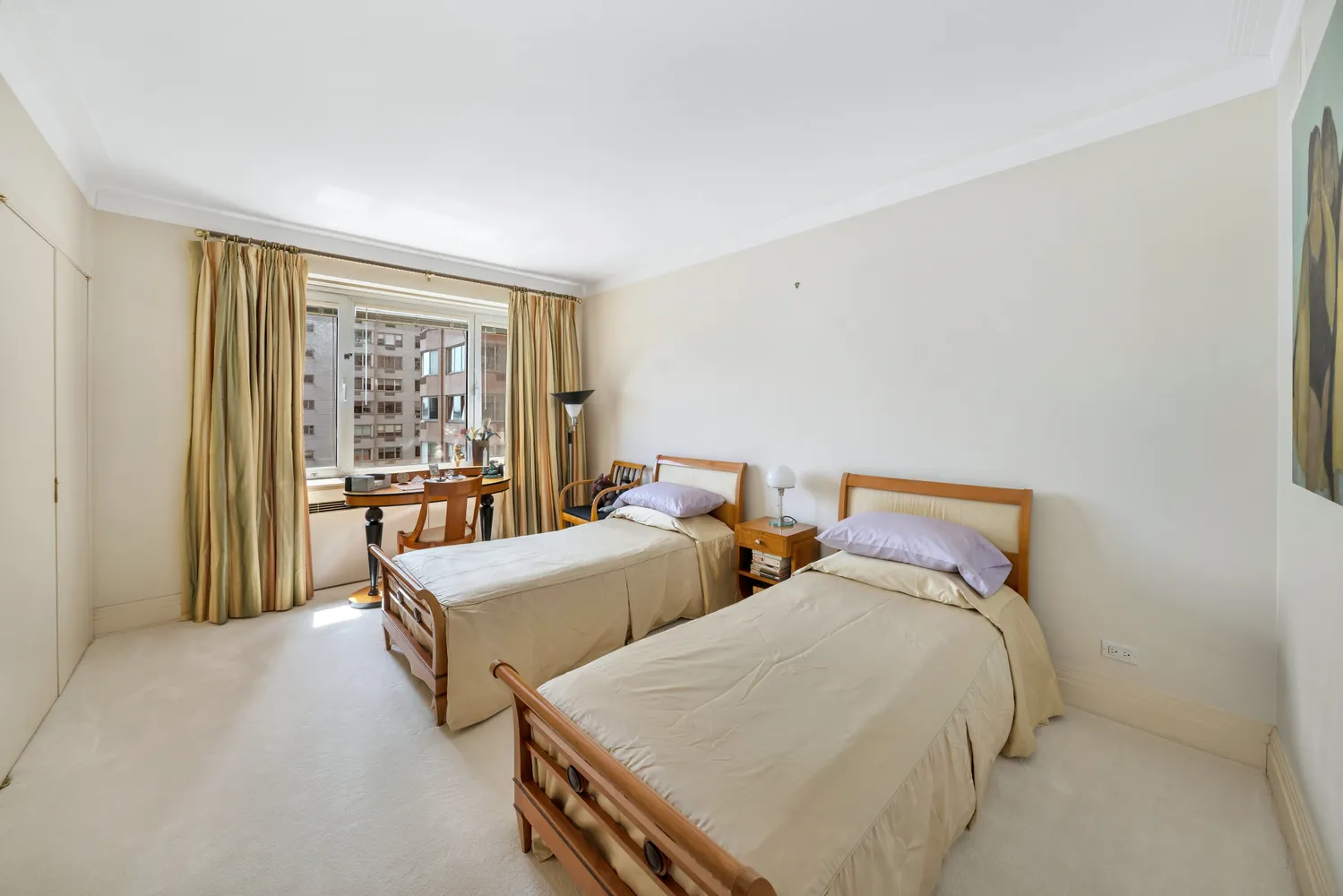 a bedroom with two beds and a window