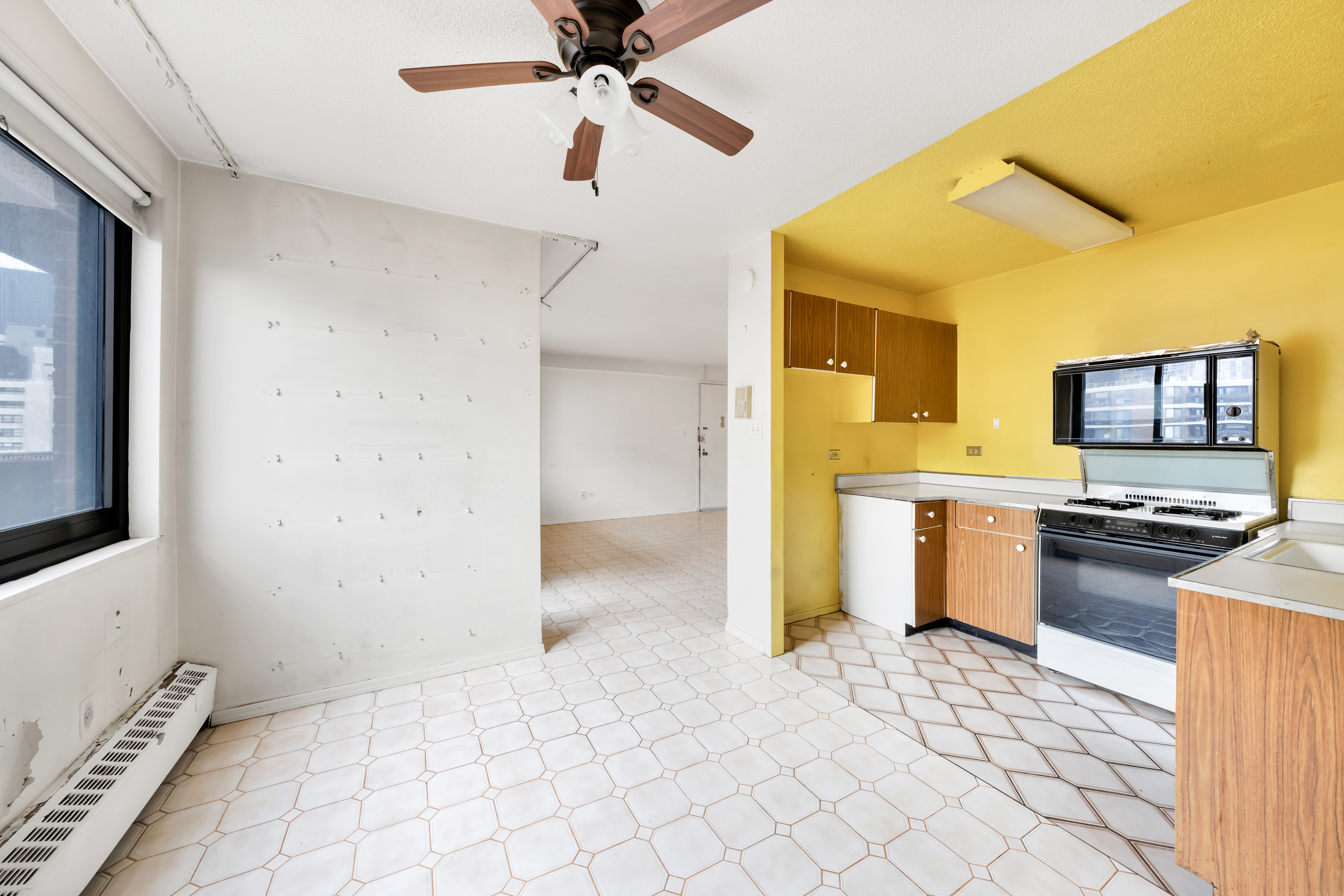 90 Gold Street, Unit 26A Manhattan, NY 10038 - Photo 3 of 6 a kitchen with stainless steel appliances a stove a sink and a refrigerator