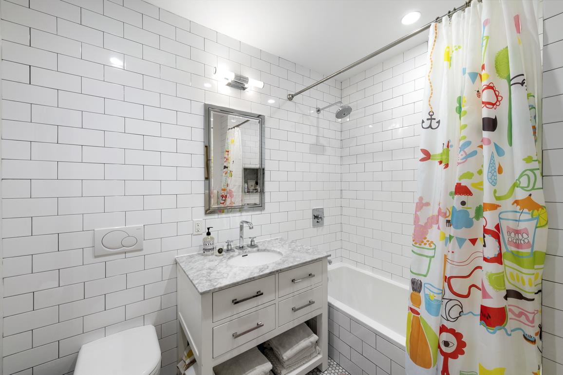 49 Summit Street, Unit 1C Brooklyn, NY 11231 - Photo 9 of 10 a bathroom with a sink a toilet and shower curtain