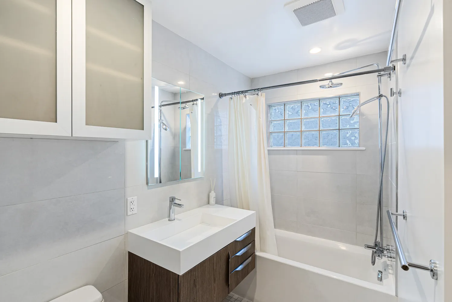 a bathroom with a bathtub a shower and a sink