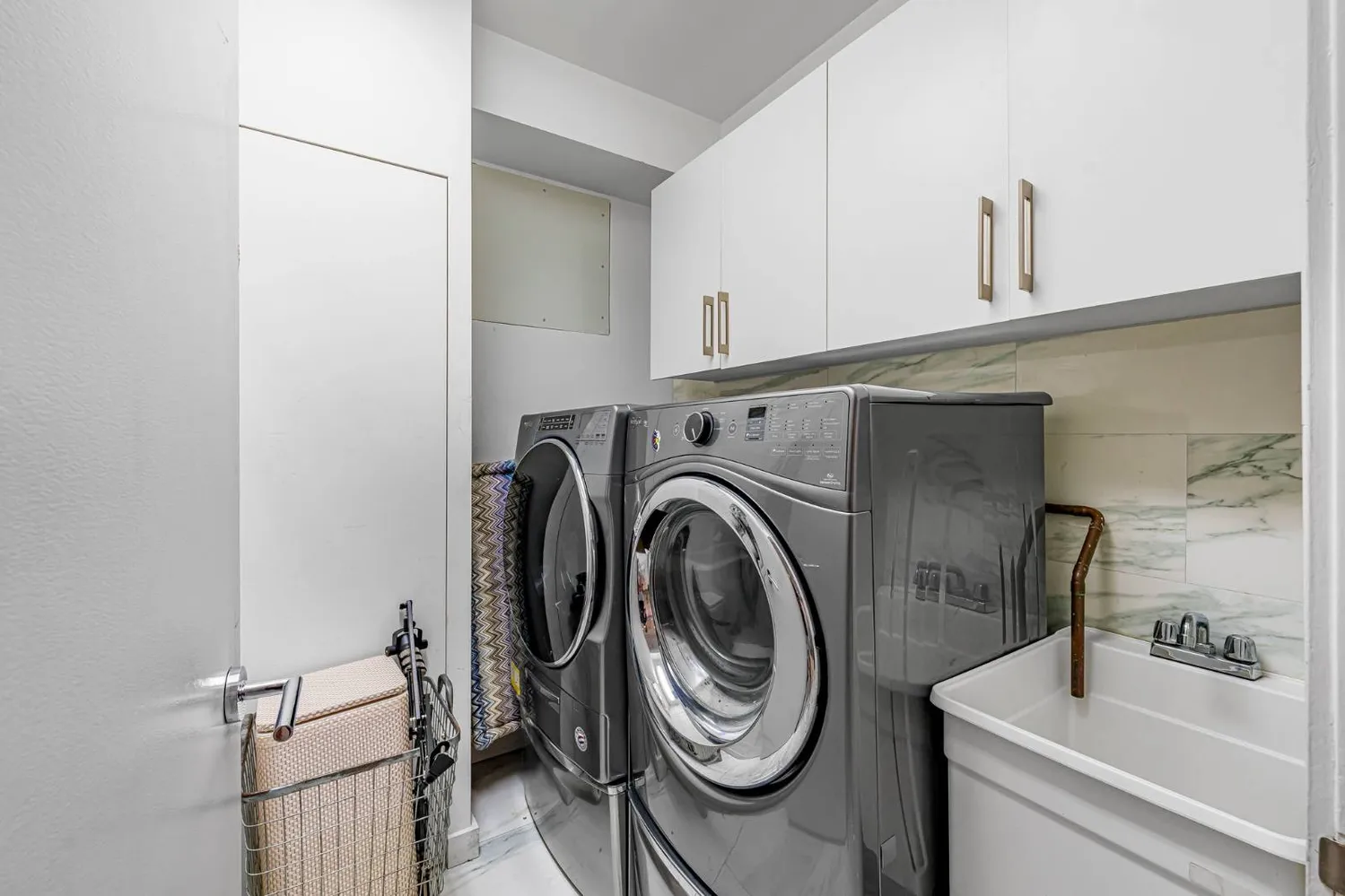 a utility room with sink dryer and washer