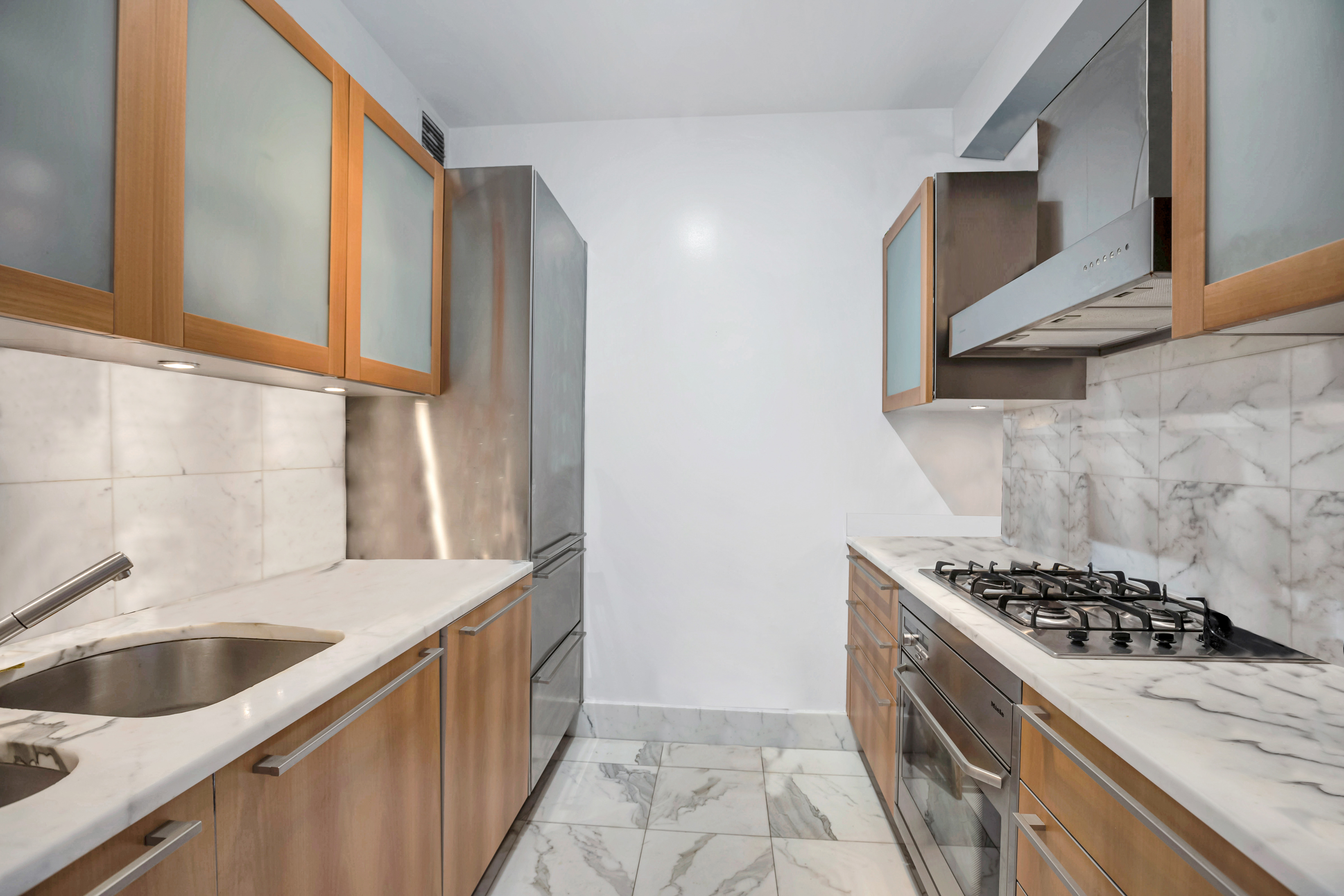 25 Columbus Circle, Unit 59F Manhattan, NY 10019 - Photo 2 of 15 a kitchen with a sink stove top oven and cabinets