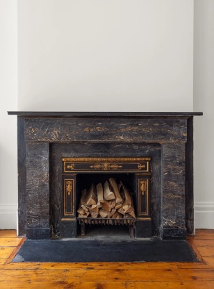 138 State Street Brooklyn, NY 11201 - Photo 9 of 13 a fireplace with a vase on top of it