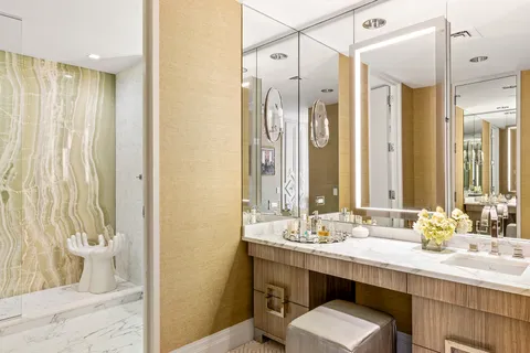 a bathroom with a double vanity sink a mirror and a shower