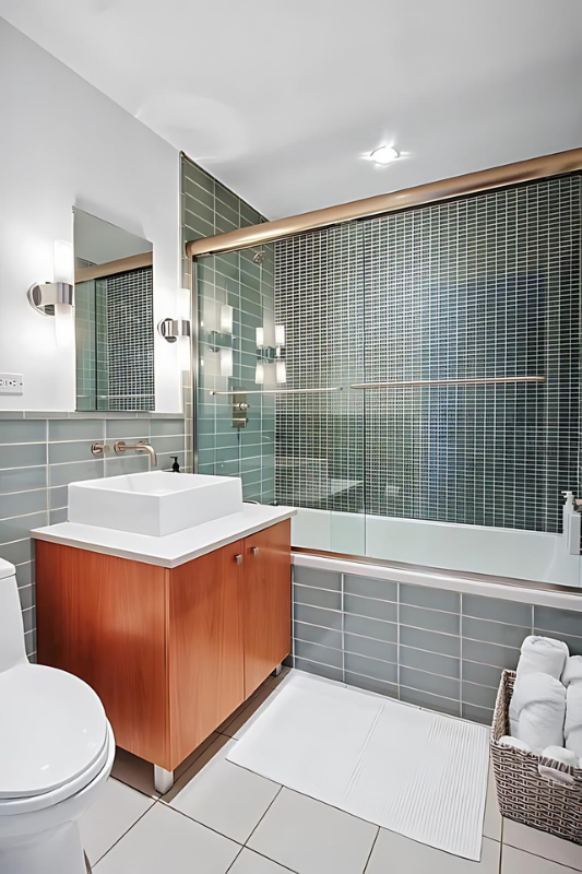 154 Attorney Street, Unit 304 Manhattan, NY 10002 - Photo 7 of 13 a bathroom with a sink a toilet a mirror and bathtub
