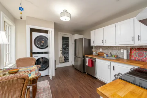 a kitchen with a refrigerator a stove top oven a sink and dishwasher