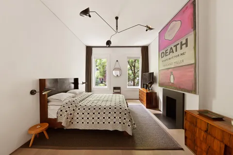 a bedroom with a bed and a fireplace