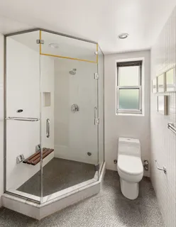 a bathroom with a toilet and a shower