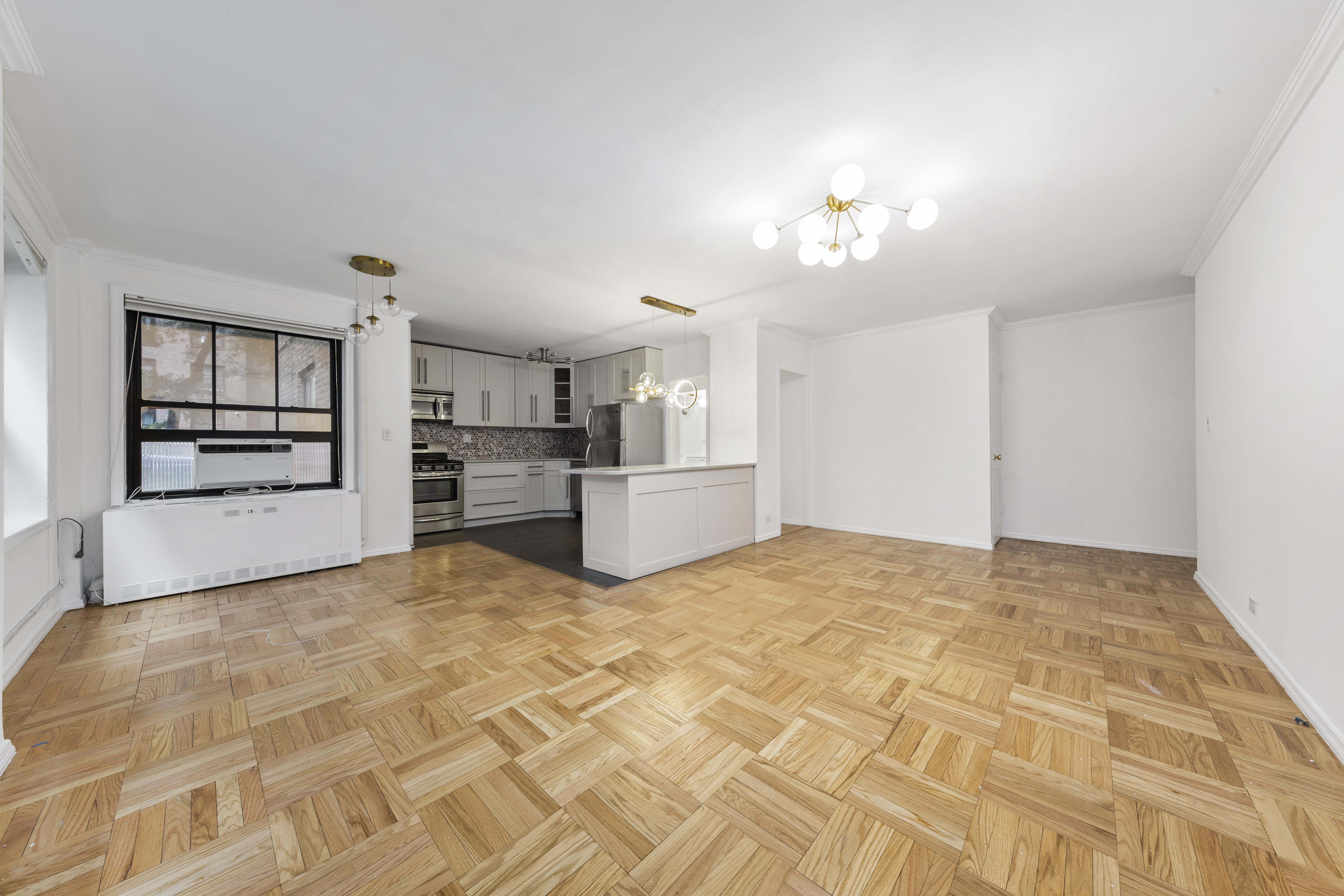 355 Clinton Avenue, Unit F1 Brooklyn, NY 11238 - Photo 13 of 20 a view of a kitchen with wooden cabinet and a refrigerator