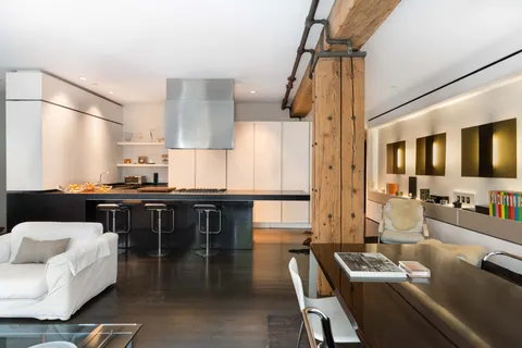 a kitchen with a table chairs stove and cabinets