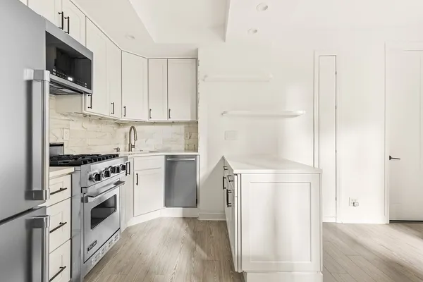 a kitchen with a refrigerator stove and microwave