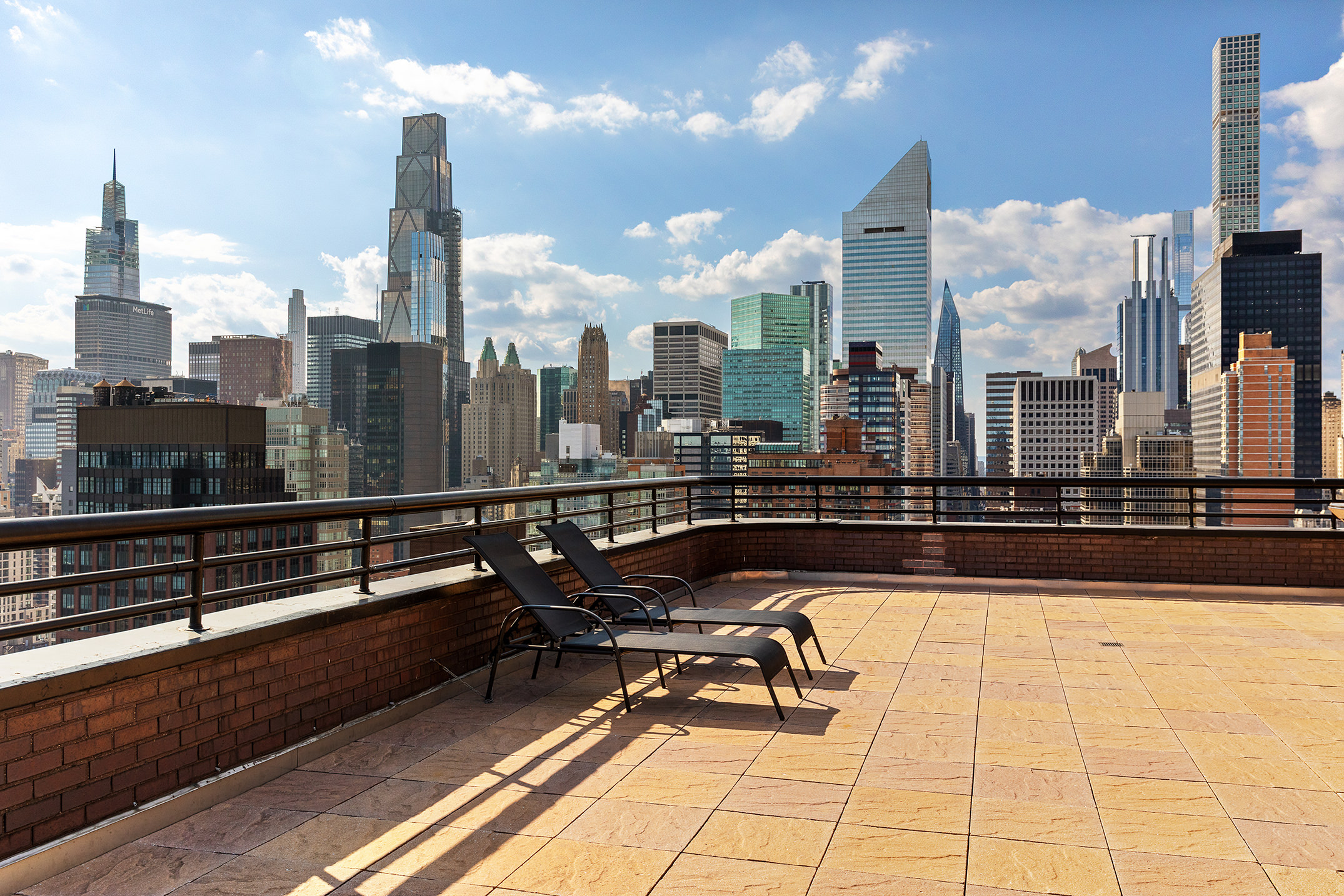 415 East 54th Street, Unit 2A Manhattan, NY 10022 - Photo 14 of 16 a view of a terrace with wooden benches