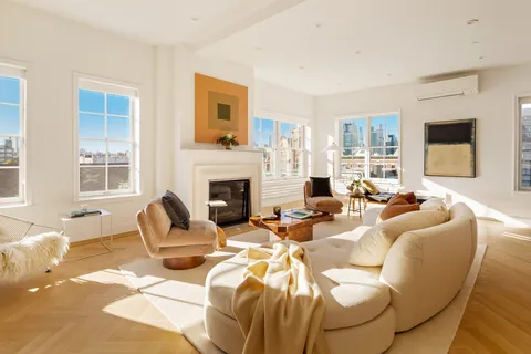 a living room with furniture windows and a fireplace
