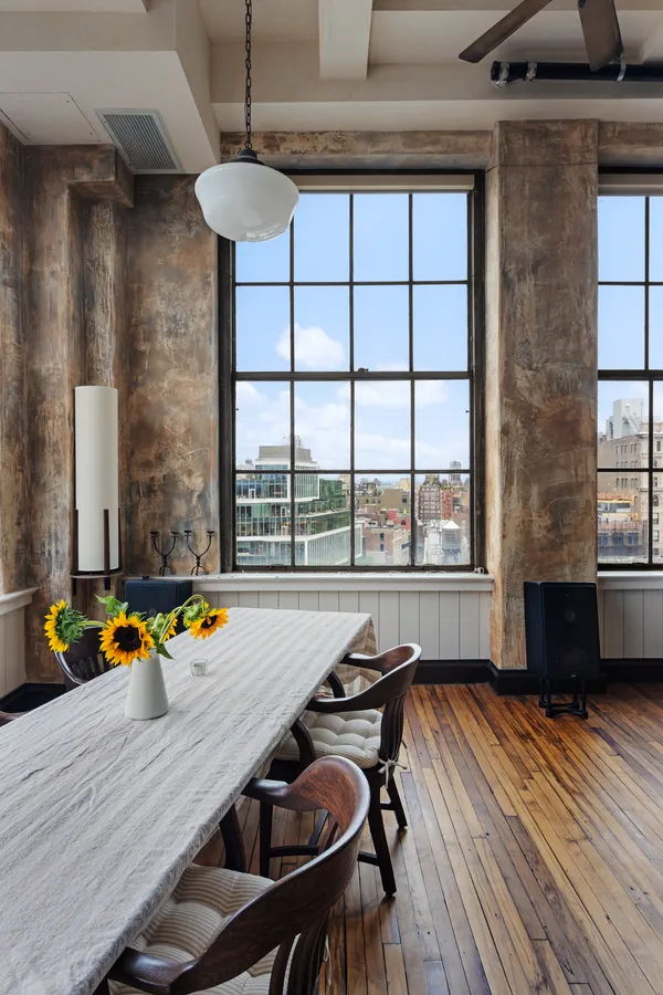 a view of a dining room with furniture a chandelier and wooden floor